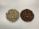 Two bowls of Honduras Finca Bethel coffee beans, one roasted and one green