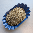 Raw Colombian coffee beans in a blue bowl.